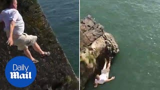 Man dangerously tombstones off cliff and lands on his back  Daily Mail [upl. by Anastasie]