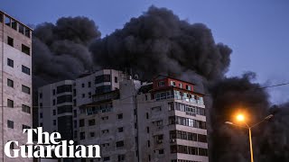 Israeli airstrike collapses tower block and Hamas rocket hits bus as violence escalates [upl. by Oinoitna]