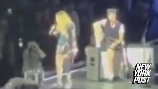 Madonna calls out concertgoer for sitting down during LA show — only to see fan is in a wheelchair [upl. by Garwin328]