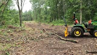 John Deere 3025e pulling out tree tops [upl. by Rases]