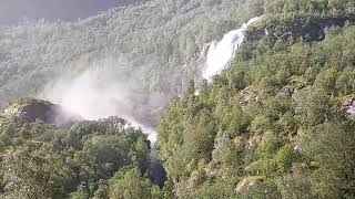 Brekkefossen waterfall surrounded by verdant green hills and rugged mountain landscapes [upl. by Lael608]