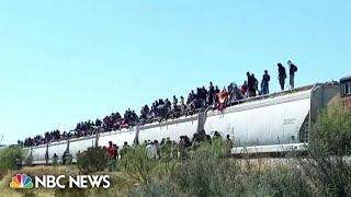 Mexico freight trains halts service after hundreds of migrants hitch rides to border [upl. by Aicekal]