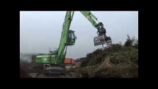 SENNEBOGEN  Recycling Material Handler 825 feeding shredder loading compost [upl. by Gelasias]