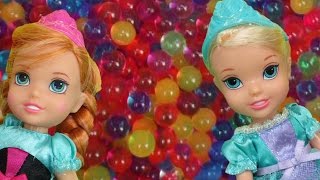 Elsa and Anna toddlers have fun in ORBEEZ  They slide into colorful water beads [upl. by Faust715]