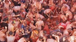 Food Fight 20000 People Toss Tomatoes at Spains La Tomatina [upl. by Karr514]