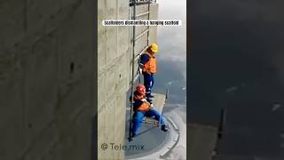 Scaffolders dismantling a hanging scaffold [upl. by Ennayar]