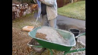 Mixing concrete by hand in a wheelbarrow the easy way [upl. by Pearman211]