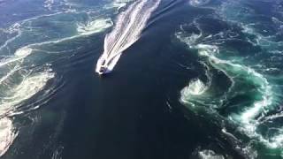 Boat cruising through Saltstraumen maelstrom near Bodø Norway [upl. by Meyer]