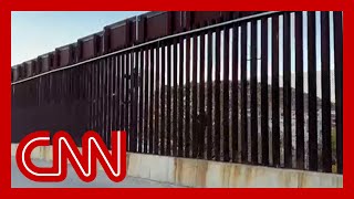 CNN cameras capture migrants attempting to scale southern border fence [upl. by Najed]