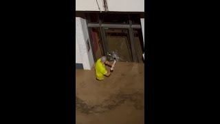 Man smashes glass door to save children in Spanish floods [upl. by Leunamne834]