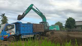 The trucks own ambition is to take soil from the KOBELCO Excavator [upl. by Dinerman855]