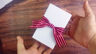 How to tie a simple ribbon on a gift box [upl. by Hanafee]