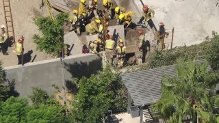 Crews work to rescue man trapped in trench [upl. by Reena42]