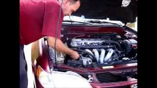 Removing the alternator from a 9802 Toyota Corolla and replacing it [upl. by Barde]